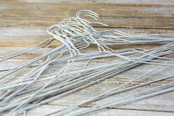 Closeup View Pile White Metal Hangers Wooden Surface —  Fotos de Stock