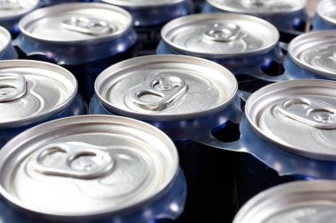 A view of several top portions of soda cans, as a background.