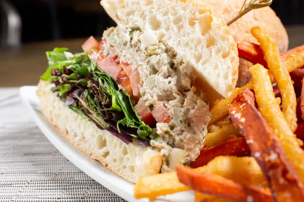 A view of a plate of a tuna salad sandwich.
