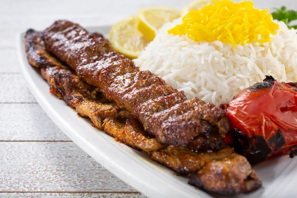 A view of combo filet mignon steak and beef soltani kabob, with saffron basmati rice.