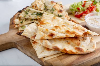 Normal naan ve sarımsaklı bir tabağın görüntüsü..