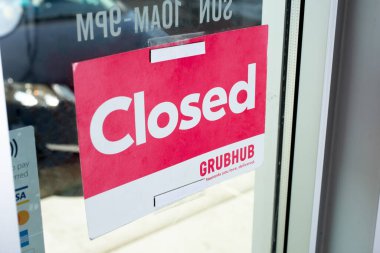 Los Angeles, California, United States - 02-24-2021: A view of a Grubhub restaurant promotional sign that advertises closed from the inside.