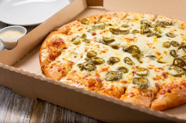 Pizza kutusundaki peynirli ekmek manzarası, bir restoranda ya da mutfak ortamında.