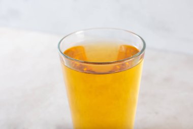 A closeup view of a glass of apple juice.