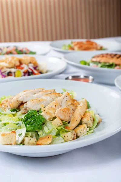 View Several Salad Plates Featuring Chicken Caesar — Stock Photo, Image