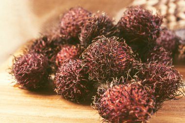 Tahta kesme tahtasındaki birkaç Rambutan meyvesiyle yakın çekim görüntüsü..