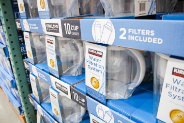 Los Angeles, California, United States - 04-06-2021: A view of several Kirkland Signature water filtration system pitchers and filter cartridges together, seen at a local Costco store.