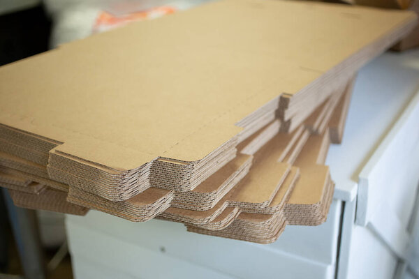 A view of a stack cardboard sheets, ready to be folded into box containers, seen at a local retail store.