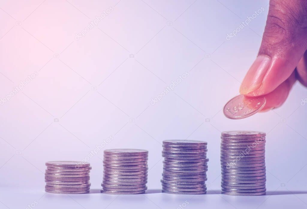 Save money and account banking for finance concept, Hand with coin on blurred background, Save Monney for Investors Using Internet to Trade Stocks or Trade Fund