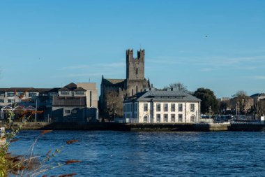 Limerick, Ireland-January, 12,2022.View of the Cathedral of the Blessed Virgin Mary and Limerick City District Court from the side of Thomond Bridge