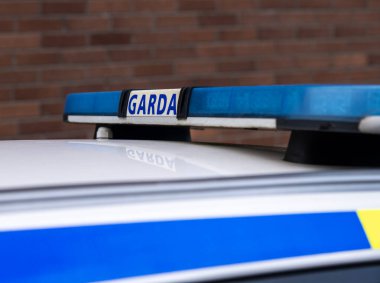 View of police emblems in Ireland, emblem on building, car, and street lantern, Limerick, Ireland,26,02, 2022
