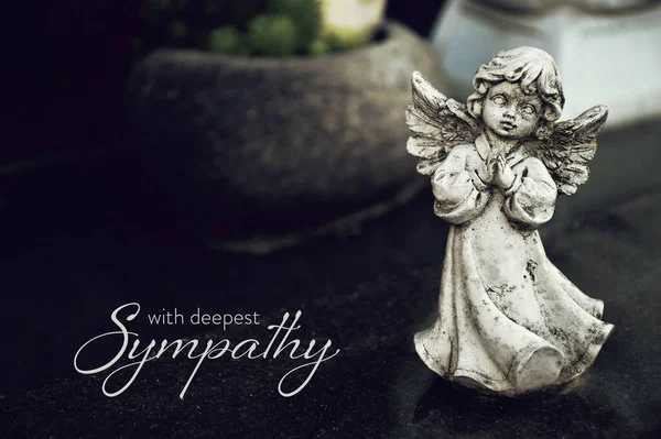 Sympathy card with angel figurine on the grave