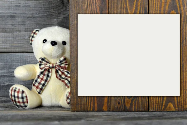 Teddy bear soft toy on wooden background with copy space