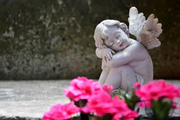 Condolence card with guardian angel sleeping on concrete background