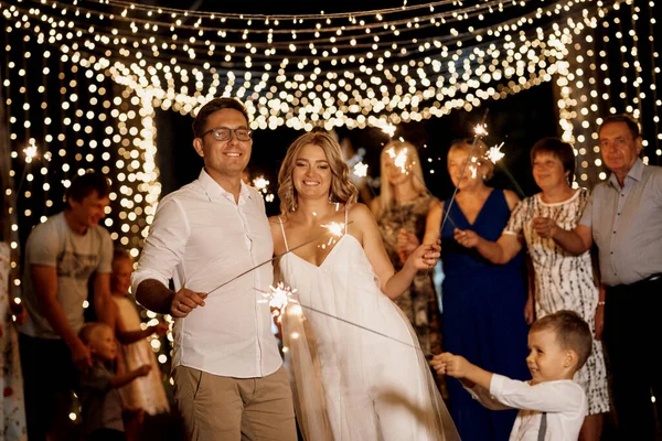 Sparklers Wedding Newlyweds Hands Joyful Guests — Photo
