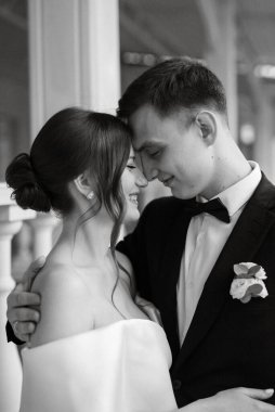 Genç çift, gelin ve damat, yağmurda yürüyen beyaz kısa elbiseli.