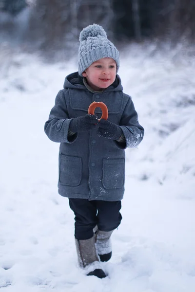 Boy Winter Coat Hat Walks Laughs Eats Bagel — Stock Photo, Image