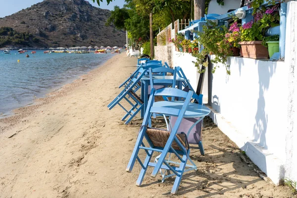 Closed cafe and folded chairs in a Greek seaside resort — Stock Photo, Image