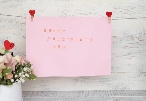 Printed inscription Happy Valentines Day on a piece of paper hanging from a rope on clothespins — 스톡 사진