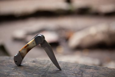 Eski kahverengi bir tahtanın üzerinde katlanan bıçak