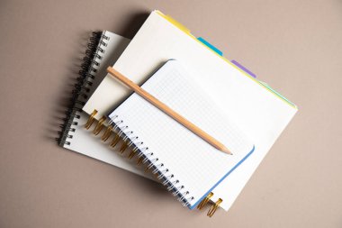 Kalem ve defterler masanın üzerinde.