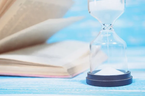 Books Hourglass Blue Wooden Table Royalty Free Stock Images