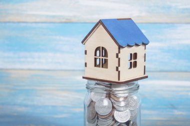 house on a bank with coins