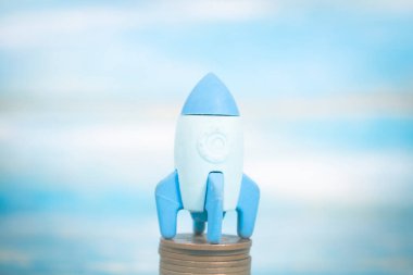 rocket on coins. concept startup