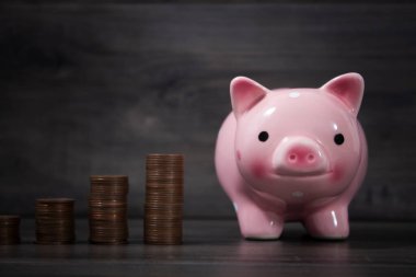 piggy bank and coins on the table in the form of a graph