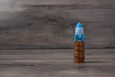 rocket on coins. concept startup.