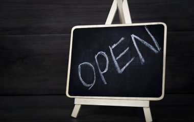 lettering open on black board
