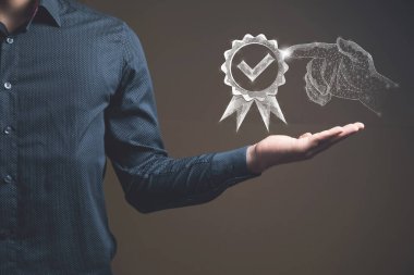 Quality assurance sign and a hand from the web. Man holding in his hand