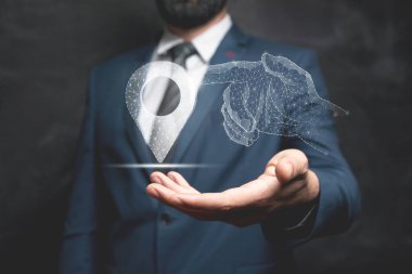 A hand from the network clicks on the GPS. Man holding in his hand