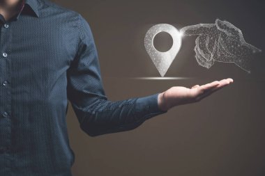 A hand from the network clicks on the GPS. Man holding in his hand