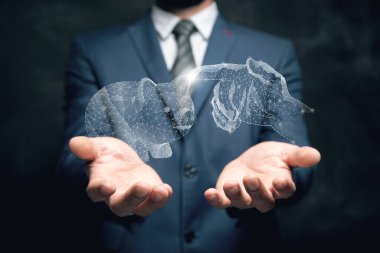 Clicks on a piggy bank from the network. Man holding in his hand