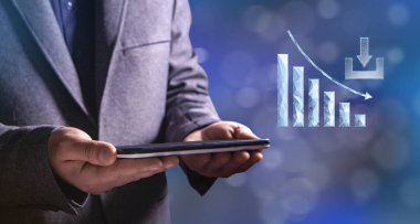 The download rate is dropping. The graph from the network goes down. Man holding a tablet in his hand