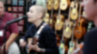 Müzisyenlerin bir müzik enstrümanı sergisinde performanslarını gösteren odaklanmış bir video..