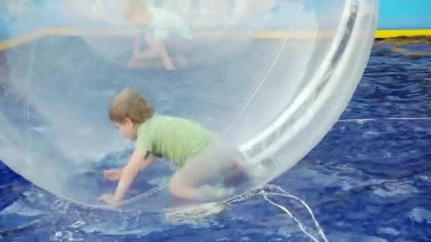 Transparent ball with a boy inside. — Stock Video