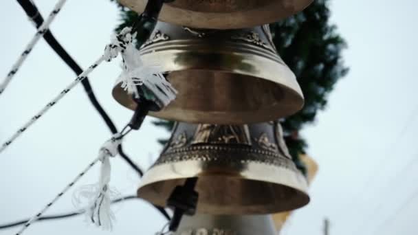 The bell-ringer pulls the strings of several bells. — Stock Video