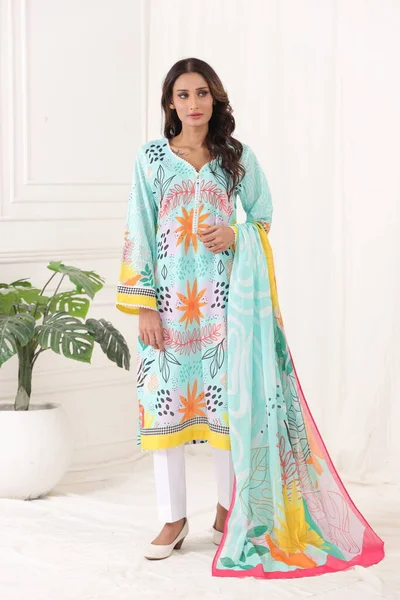 A Pakistani shalwar kameez suit with dupatta. Pakistani model is shown her dress with style.