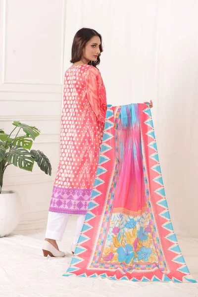 A Pakistani shalwar kameez suit with dupatta. Pakistani model is shown her dress with style.