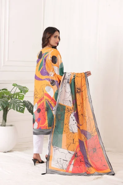 A Pakistani shalwar kameez suit with dupatta. Pakistani model is shown her dress with style.