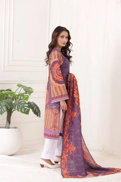 A Pakistani shalwar kameez suit with dupatta. Pakistani model is shown her dress with style. Indian dress.