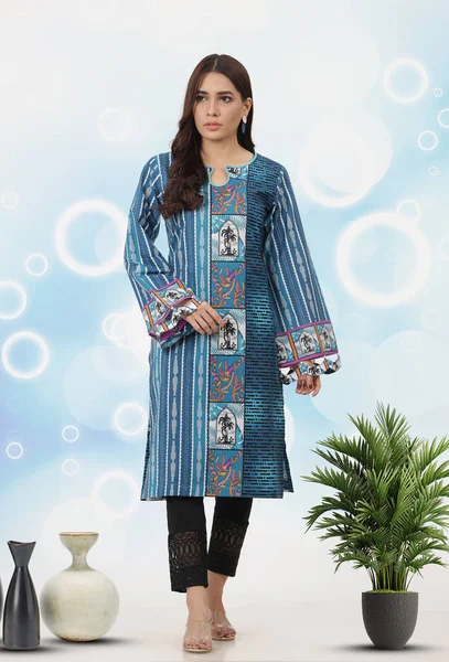 A Pakistani shalwar kameez suit with dupatta. Pakistani model is shown her dress with style.
