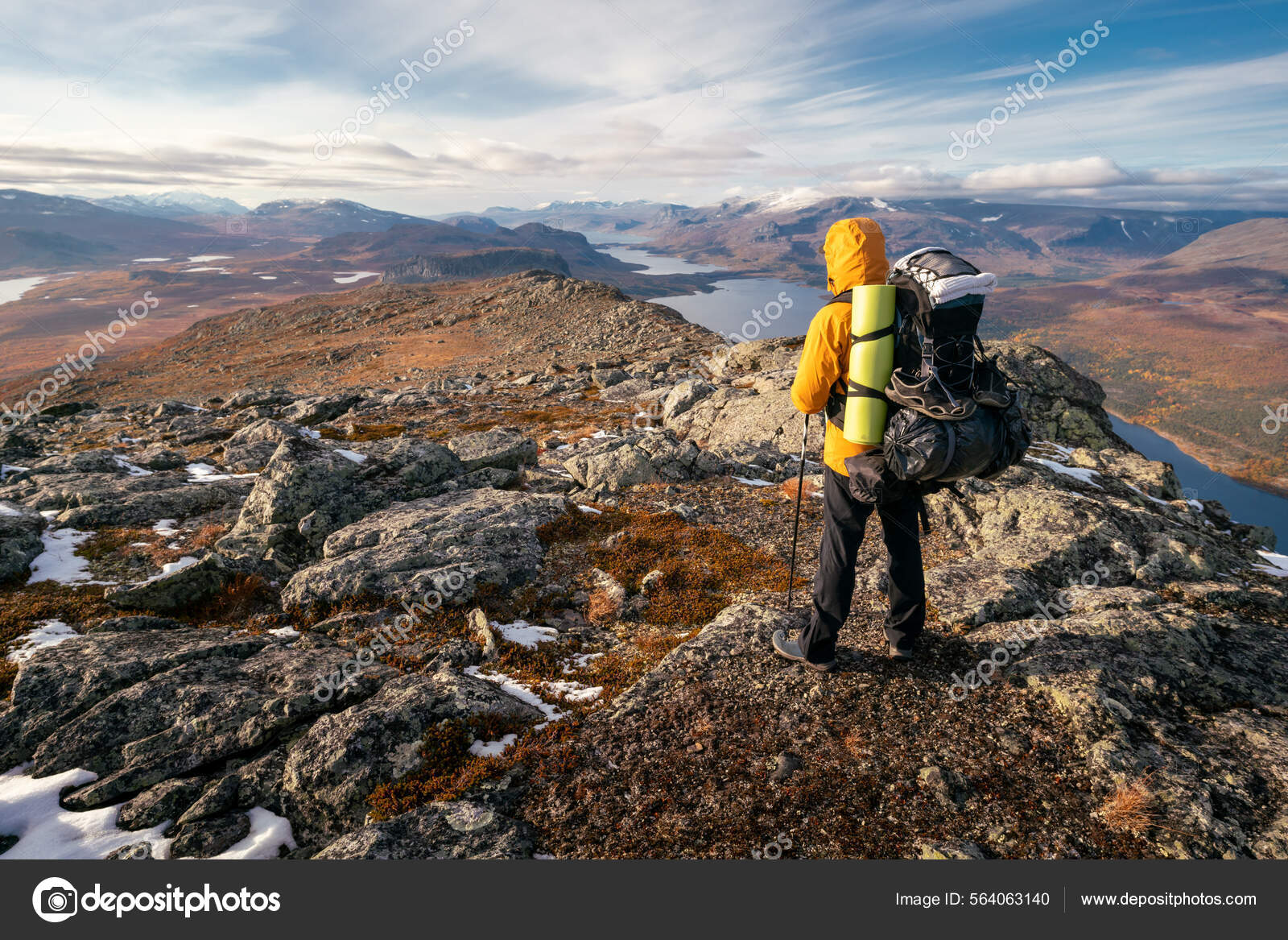 Male hiker overlooking epic view of vast arctic landscape of Stora