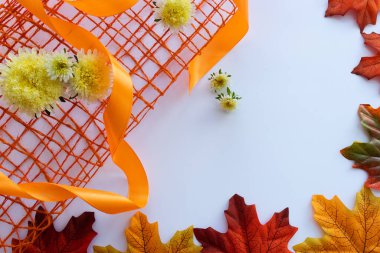 Sonbahar yaprakları, sarı çiçekler ve hediye kurdelesi çerçevesi. Sonbahar arkaplanı.