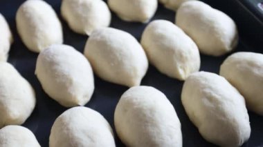 Yedek çarşafı olan çiğ turtalar. Kameranın hareketi.