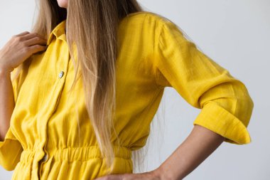 Woman in yellow dress with wet armpits. Closeup