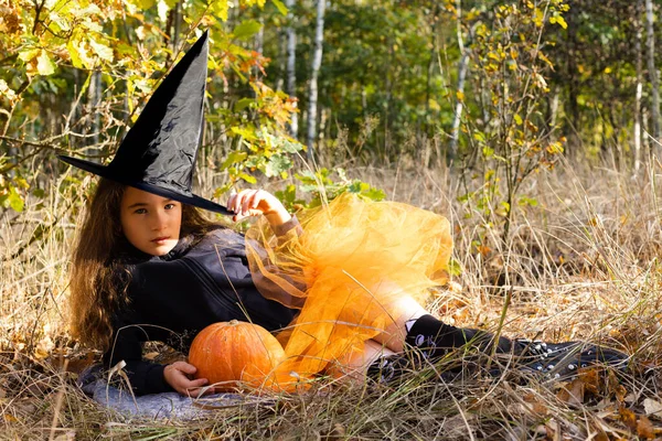Little Girl Dressed Witch Orange Skirt Pumpkin Hands Forest Halloween — Stockfoto
