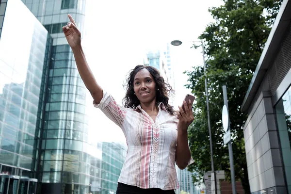 Black business woman waving taxi. Business environment. Striped white shirt.
